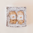Load image into Gallery viewer, Chocolate chip cookies packaged in clear bags in a white gift box with white paper filler