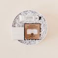 Load image into Gallery viewer, Lavender and Pine Love at First Site Gift Box featuring ElizabethW lavender shea butter hand cream, ElizabethW lavender exfoliating shower pouch, and Shinery radiance towelettes in white round gift box