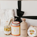 Load image into Gallery viewer, Lavender and Pine Pizza Night Gift Box detail view featuring Le Marké olive oil, Bella Cucina pizza and focaccia mix, Bella Cucina pomodoro pizza sauce, French Farm L'Epicurien sweet garlic and herbs, stainless garlic rocker, and Kaf Home striped kitchen towel set in white magnetic gift box