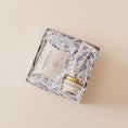 Load image into Gallery viewer, Lavender and Pine Ultimate Comfort Trio Gift Box angle view featuring Candlefish No. 31 candle tin, Lanolips 101 ointment, and McCrea's Cape Cod sea salt caramels in mini tuck top gift box