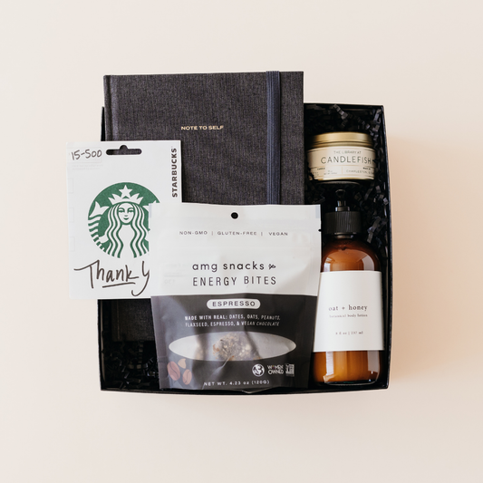 Employee appreciation gift box by Lavender + Pine featuring energy bites, oat + honey lotion, a notebook, candle, and Starbucks gift card.