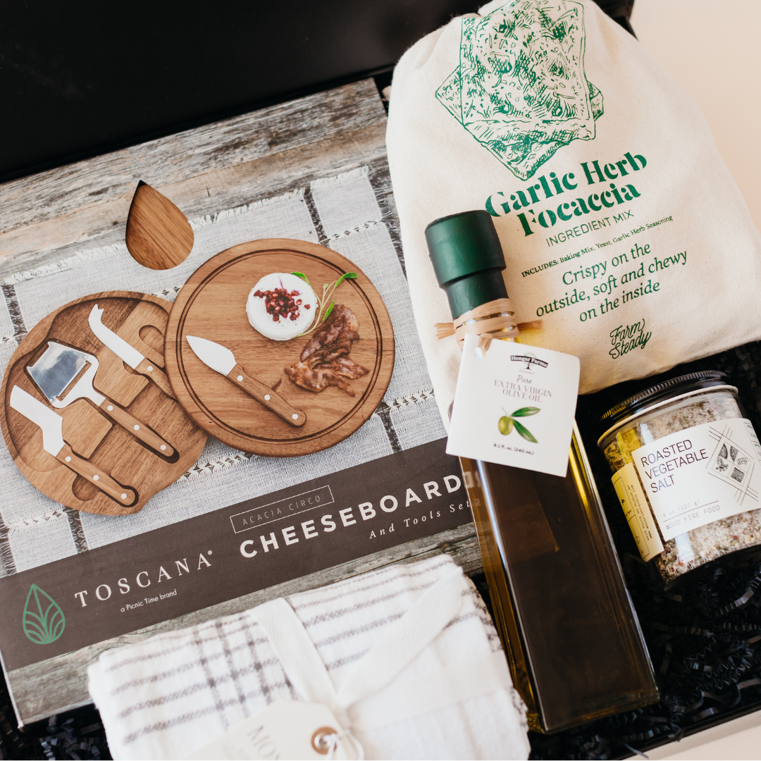 Luxury closing gift box for home buyers featuring cheese board set, focaccia mix, olive oil, and gourmet seasonings.