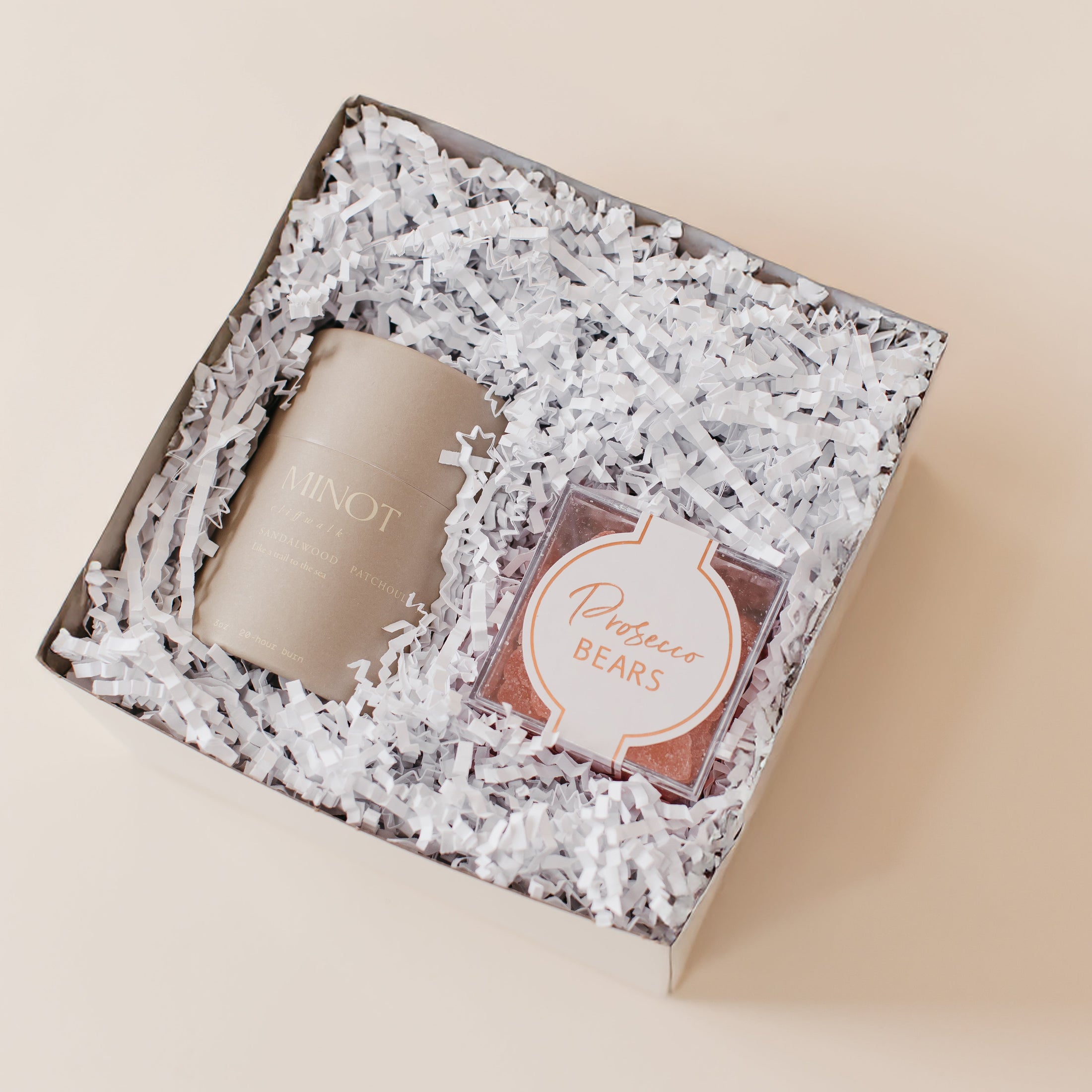 Lavender and Pine Bubbly and Glow Gift Box angle view featuring Minot Cliffwalk candle and Prosecco Bears in mini white tuck top gift box