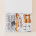 Load image into Gallery viewer, Lavender and Pine Entertainer's Kitchen Gift Box featuring Kaf Home grey linen napkins, Le Marké olive oil, Natural OliveWood pasta spoon, Natural OliveWood salt and pepper mills, and La Boite grey salt and Tellicherry pepper in white magnetic gift box
