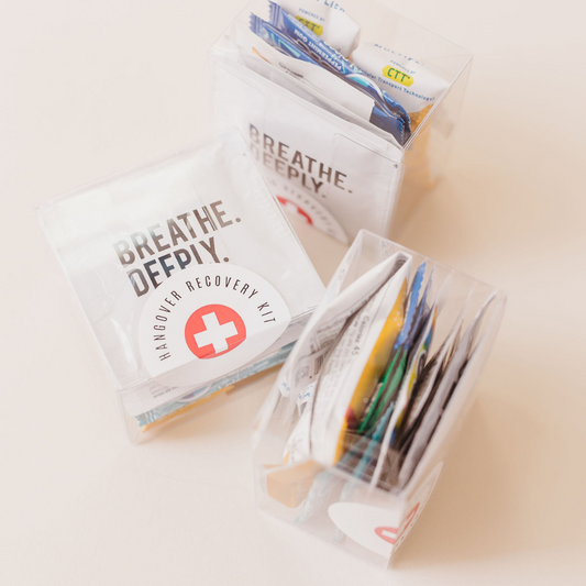 Hangover recovery kits with Breathe Deeply label shown from multiple angles in clear boxes