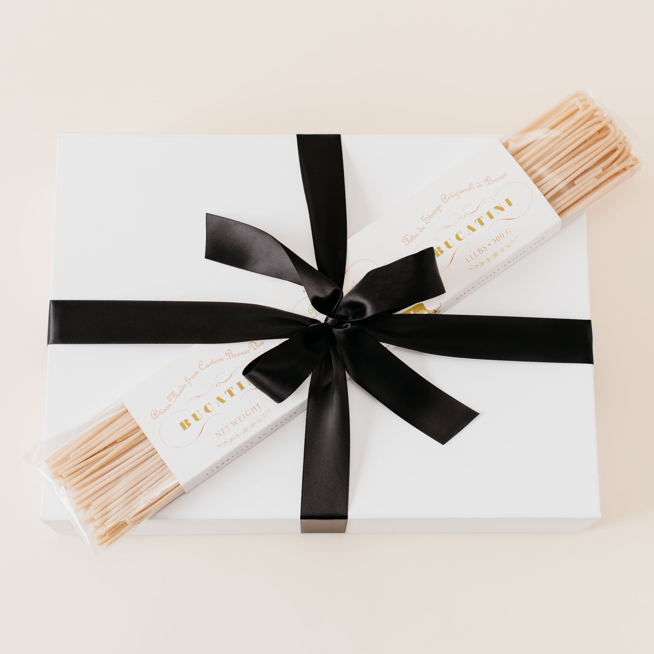 Lavender and Pine Pasta Gift Box wrapped in black satin ribbon with Bella Cucina bucatini pasta in white magnetic gift box