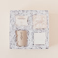 Load image into Gallery viewer, Lavender and Pine Refined Escape Gift Box featuring McCrea's Cape Cod sea salt caramels, Thulisa Naturals shower steamer discovery set, Minot Cliffwalk candle, and Shinery radiance towelettes in white luxe two piece gift box
