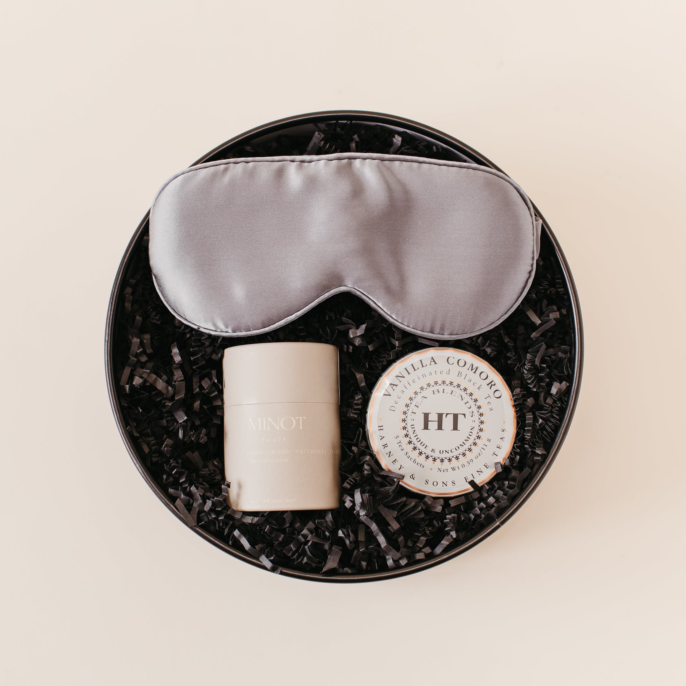 Lavender and Pine Ultimate Bliss Gift Box featuring Pure Sol silk sleep mask, Minot candle, and Harney and Sons Vanilla Comoro tea tin in black round gift box